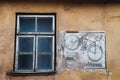 Old window frame and an old logo on the wall of the houseÃÂ 